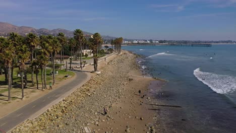 Excellent-Aerial-Shot-Of-Waves-Lapping-The-Shore-At-Surfers-Point-In-Ventura,-California