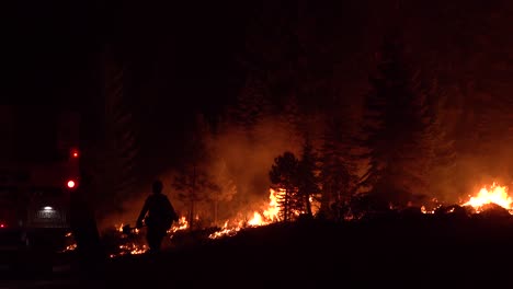 Exhausted-Firefighters-Look-On-At-Night-During-The-Disastrous-Dixie-Fire-In-Northern-California