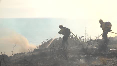 Los-Bomberos-Usan-Una-Manguera-Y-Agua-Contra-Las-Llamas-Del-Incendio-Alisal-Que-Arde-A-Lo-Largo-De-La-Costa-De-Gaviota-En-El-Condado-De-Santa-Barbara