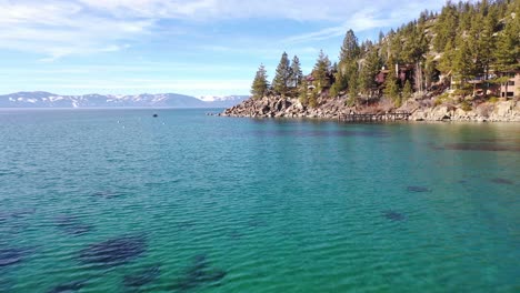 A-Nice-Drone-Aerial-Over-Lake-Tahoe,-Nevada,-Past-A-Peninsula-And-Fishing-Boat-On-The-Water