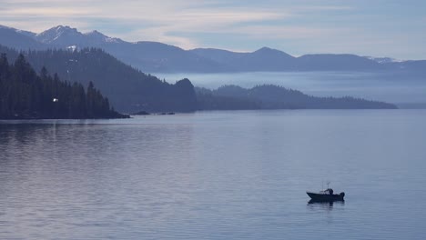 A-Fishing-Boat-Is-Silhoutted-Against-The-Beauty-Of-Lake-Tahoe,-Nevada,-California-Winter