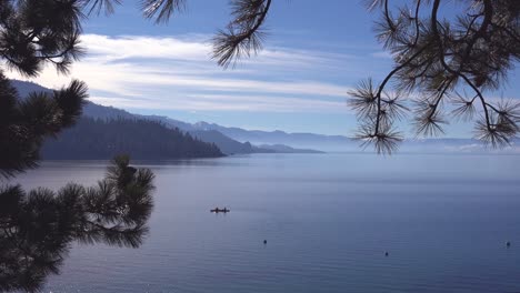 Two-Kayaks-Kayakers-Couple-Kayaking-Rowing-On-The-Calm-Waters-Lake-Tahoe,-Nevada,-California-In-Winter