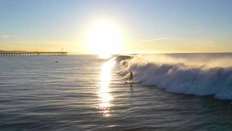 Aerial-Of-Surfers-Riding-Large-Ocean-Waves-With-Surf-Breaking-Off-The-Coast-Of-Ventura,-California