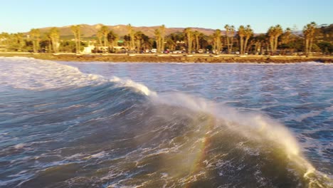 Aerial-Of-Surfer-Surfing-Riding-Large-Ocean-Waves-With-Surf-Breaking-Off-The-Coast-Of-Ventura,-California