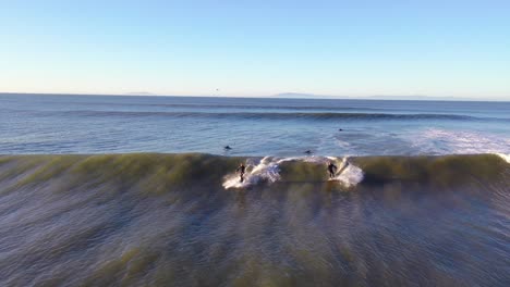 Aerial-Of-Surfer-Surfing-Riding-Large-Ocean-Waves-With-Surf-Breaking-Off-The-Coast-Of-Ventura,-California