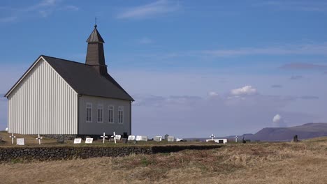 Massive-Volcanic-Plume-Or-Somke-Cloud-Rises-Behind-A-Pretty-Church,-Strandakirkja,-In-Iceland