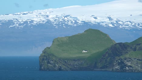 A-Remote-And-Lonely-Summer-Cottage-On-A-Small-Island-In-The-Westman-Islands-Of-Iceland-With-Mýrdalsjökull-Glacier-In-Background