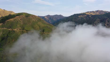 Aerial-Shot-Through-The-Fog-Reveals-The-A-Narrow-Road-In-The-Remote-Mountains-Along-California'S-Highway-One-Pacific-Coast-Highway-Near-Big-Sur