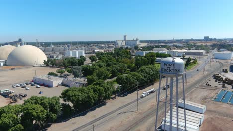 Establishing-Aerial-Of-Port-Of-Stockton-Industrial-Area-With-Trucks-And-Smokestacks