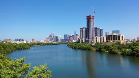 Hermosa-Antena-Sobre-El-Río-Colorado-En-El-Centro-De-Austin,-Texas-Con-Fondo-De-Horizonte