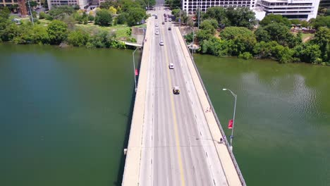 Tilt-Up-Aerial-Along-Congress-Street-In-Downtown-Austin-Texas-Reveals-The-State-Capitol-Building-In-The-Distance