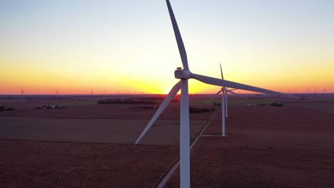 Excellent-Aerial-Of-Windmills-Generating-Clean-Electricity-On-The-Flat-Farmlands-Of-Indiana,-Illinois,-At-Dawn-Or-Sunset