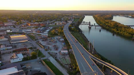 Aerial-Over-Freeway-Interchange-In-Louisville,-Kentucky-With-Ohio-River-Background-Suggests-Infrastructure