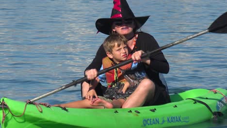 Witches-In-Costume-Paddle-On-Surfboards-And-Paddleboards-To-Celebrate-Halloween-In-Ventura-Harbor,-California