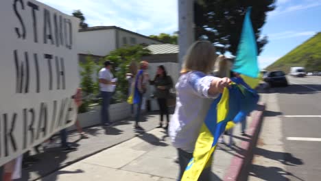 A-Woman-Ukrainian-Antiwar-Protester-Waves-A-Flag-On-The-Malibu-Pier-To-Protest-The-Russian-Invasion-Of-Ukraine