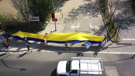 Aerial-Ukrainian-Antiwar-Protesters-Display-A-Long-Flag-And-Signs-On-Pacific-Coast-Highway-Pch-Malibu-California-To-Protest-The-Russian-Invasion-Of-Ukraine