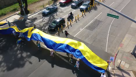 Aerial-Ukrainian-Antiwar-Protesters-Display-Flags-And-Signs-In-Malibu-California-To-Protest-The-Russian-Invasion-Of-Ukraine