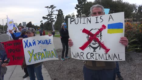 Putin-Is-A-War-Criminal-Sign-Held-By-Ukrainian-Protesters-After-Russia-Invades-Ukraine