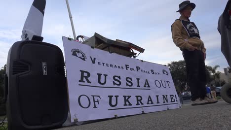 Protesters-Gather-To-Hold-Signs-In-Support-Of-Ukraine-Following-Russia-Invasion,-With-One-Sign-Identifying-Putin-As-A-Killer