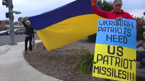 Protesters-Gather-To-Hold-Flags-And-Signs-In-Support-Of-Ukraine-Following-Russia-Invasion