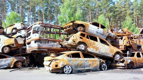 Aerial-Of-Wrecked-And-Burned-Cars-Sitting-In-A-Pile-Many-With-Bullet-Holes-From-Russian-Aggression,-Irpin-Ukraine