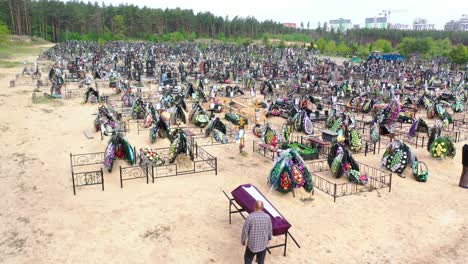 Rising-Aerial-Of-A-Father-Standing-Beside-A-Coffin-In-Irpin-(Kyiv)-Ukraine-Following-Russian-Aggression-In-The-War