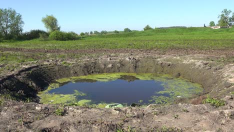 A-Huge-Bomb-Impact-Crater-On-The-Battlefield-Near-Moschun-During-The-War-In-Ukraine