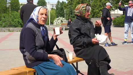 Old-Ukrainian-Refugee-Women-Enjoy-Refreshment-In-Borodyanka,-Ukraine-Following-Russian-Airstrikes-Which-Destroyed-Most-Of-Their-City