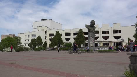 Establishing-Shot-Of-The-Badly-Damaged-Borodyanka-Palace-Of-Culture-With-Statue-Of-Ukrainian-Poet-Taras-Shevchenko-Foreground