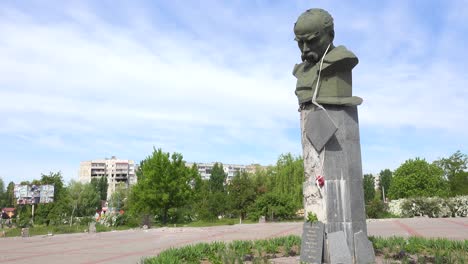 Einspielung-Des-Stark-Beschädigten-Kulturpalastes-Borodyanka-Mit-Statue-Des-Ukrainischen-Dichters-Taras-Shevchenko-Im-Vordergrund-Mit-Einschussloch-Durch-Den-Kopf