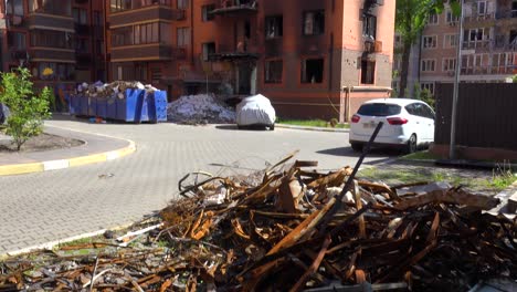 Tilt-Down-From-A-Destroyed-Apartment-Building-In-Irpin,-Ukraine-To-Baby-Carriage-Sitting-In-Rubble-Following-Russian-Airstrikes