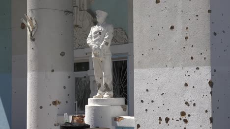 Statues-Stand-In-Front-Of-The-Devastated-Exterior-Of-The-Bucha-Concert-Music-Hall-In-Bucha,-Ukraine-Following-The-Russian-Invasion