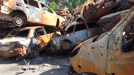 Wrecked-And-Burned-Cars-In-The-Car-Cemetery-Sitting-In-A-Pile-Many-With-Bullet-Holes-From-Russian-Aggression,-Irpin-Ukraine