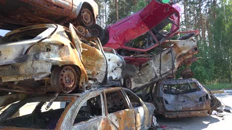 Wrecked-And-Burned-Cars-In-The-Car-Cemetery-Sitting-In-A-Pile-Many-With-Bullet-Holes-From-Russian-Aggression,-Irpin-Ukraine