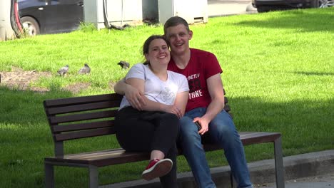 Ukrainian-Lovers-Sit-On-A-Park-Bench-In-The-Sun-In-Central-Lviv,-Ukraine