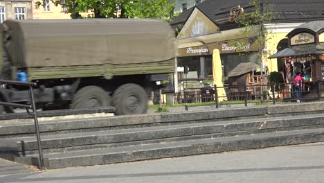 Military-Army-Transport-Vehicles-Make-Their-Way-Down-A-Public-Street-In-Lviv,-Ukraine