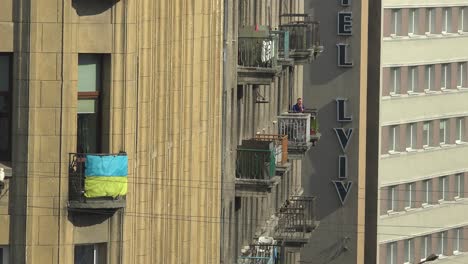 A-Man-Sits-On-A-Balcony-At-A-Hotel-Overlooking-Lviv,-Ukraine