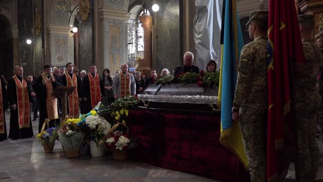 A-Catholic-Priest-Administers-Last-Rites-Over-The-Coffin-Of-A-Dead-Ukrainian-Soldier-During-A-Funeral-Service-In-Lviv,-Ukraine