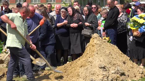 A-Mother-Looks-On-With-Her-Family-At-The-Funeral-Of-Her-Father-In-Lviv-Ukraine