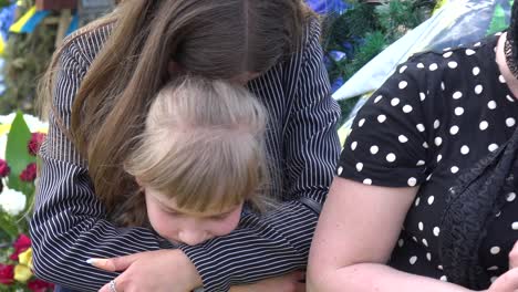 A-Beautiful-Girl-Holds-A-Ceremonial-Flag-With-Her-Family-At-The-Funeral-Of-Her-Father-In-Lviv-Ukraine