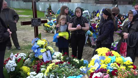 A-Wife-And-Daughter-Say-Goodbye-To-Their-Soldier-Husband-And-Father-At-His-Funeral-During-The-War-In-Ukraine