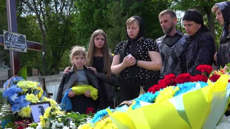 A-Beautiful-Girl-Holds-A-Ceremonial-Flag-With-Her-Family-At-The-Funeral-Of-Her-Father-In-Lviv-Ukraine