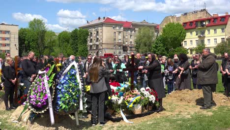 A-Large-Family-Gathering-For-The-Burial-At-The-Gravesite-Of-A-Fallen-Ukrainian-Soldier-In-Lviv,-During-The-War-In-Ukraine