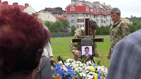 Soldiers-Place-The-Photo-Of-A-Fallen-Comrade-On-A-Cross-In-A-Cemetery-During-The-War-In-Ukraine