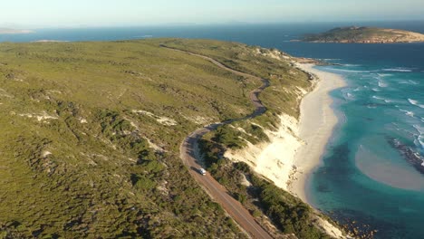 Excellent-Aerial-Shot-Of-An-Rv-Driving-On-Great-Ocean-Drive-Towards-The-Beach-In-Esperance,-Australia