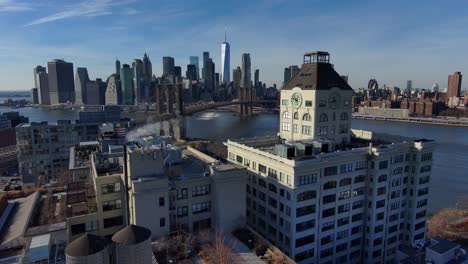 Excellent-Aerial-Of-Dumbo-Brooklyn-Apartments-With-Brooklyn-Bridge,-East-River-And-New-York-City-Skyline-In-Distance