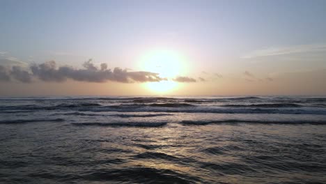 Excellent-Aerial-View-Skimming-Over-The-Waves-At-Sunrise-At-New-Smyrna-Beach,-Florida