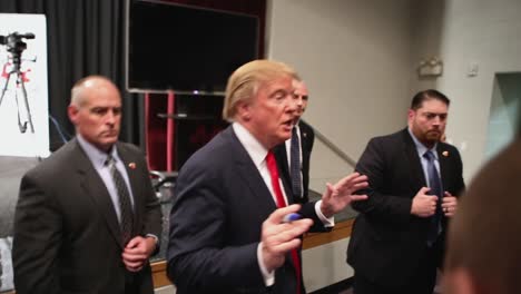 Presidential-Candidate-Donald-Trump-Signs-An-Autograph-And-Answers-A-Question-About-A-Muslim-Ban-After-Republican-Iowa-Caucus-Primary-Campaign-Rally