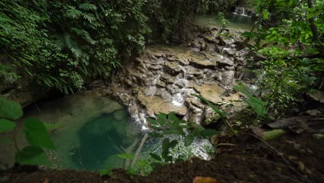 Excellent-Aerial-Shot-Of-Small-Waterfalls-In-The-Chiapas-Rainforest-Of-Mexico,-Surrounded-By-Greenery