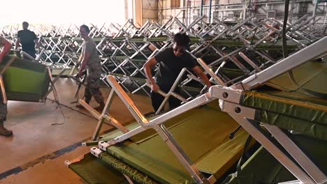 Us-Army-Personnel-Set-Up-Cots-And-Beds-At-An-Afghanistan-Refugee-Center-At-Ramstein-Air-Base,-Germany-During-The-Emergency-Evacuation